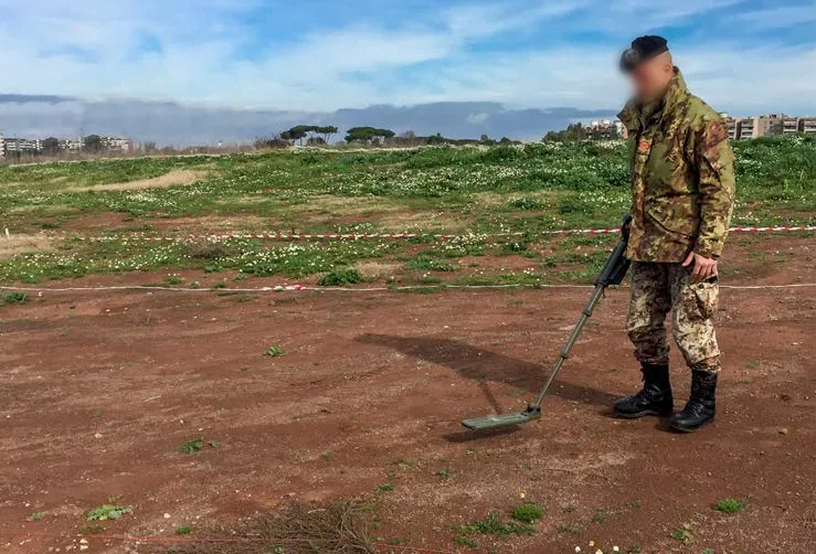 A searcher sweeping a CEIA CMD3 detector across open ground