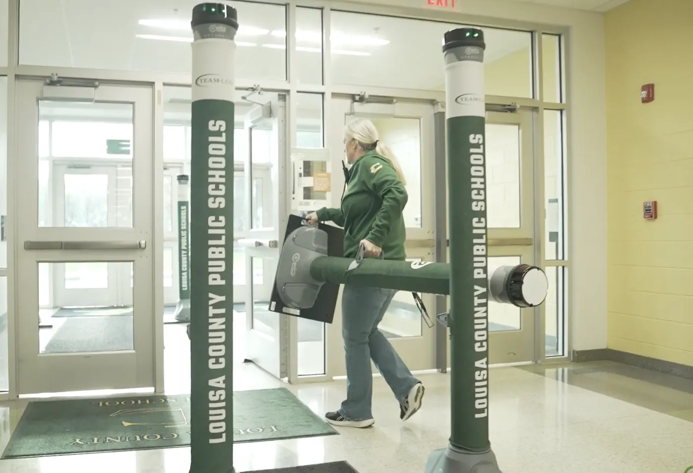 A member of staff carrying an OPENGATE pillar between entrances