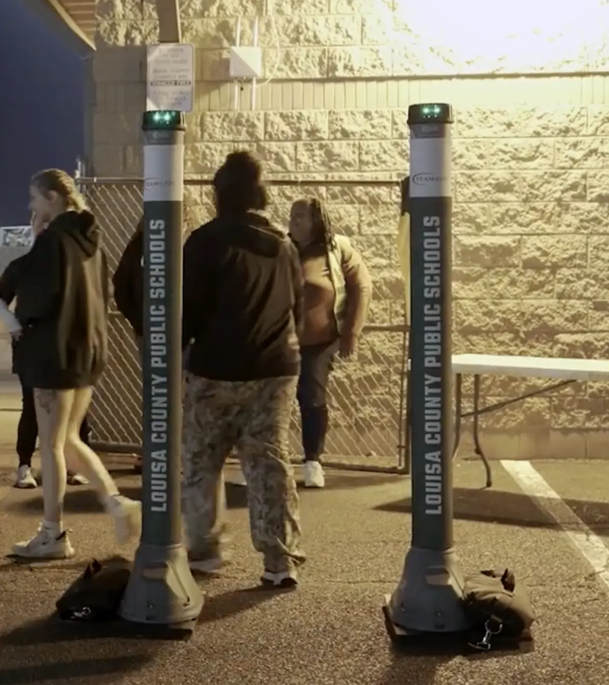 Students walking through OPENGATE at an evening school event